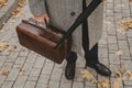 Close-up of carpetbag in hand of intelligent man