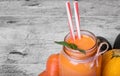 Close-up of carrot drink on a wooden background. A cocktail with carrots and zucchinis. Vegetarian juices. Copy space. Royalty Free Stock Photo