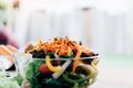 Close up carrot with salad in chalice on desk