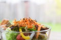 Close up carrot with salad in chalice on desk.