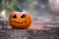 Smoking jack o\' lantern in the forest