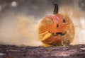 Smoking jack o\' lantern in the forest