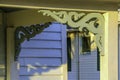 A pair of decorative wooden porch brackets on an old house.