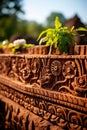 a close up of a carved stone wall with plants growing on it