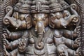 A close up of a carved wodden Ganesha with many details