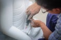 Close-up carvers using electric drill on a marble to carve