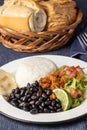 Close up of Casado, typical Costa Rican dish with rice and beans on blue tablecloth