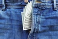 Close up of cash US dollars sticking out of denim jeans zipper Royalty Free Stock Photo