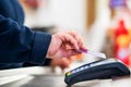 Close up of cashier is using contactless credit card pos terminal to getting the payment. Royalty Free Stock Photo