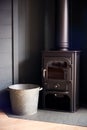 Close Up Of Cast Metal Wood Burner And Bucket In Modern Lounge