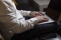 Close up of casual businessman working through a laptop at the table on sofa at home, student studying an online course, E- Royalty Free Stock Photo