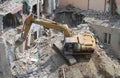 Close up of caterpillar excavator demolishing building