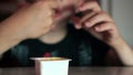 Close-up of a Caucasian boy dips French fries in sauce and eats with gusto in a cafe. Selective focus,