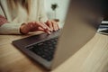 Close up caucasian couple typing on laptop sitting at kitchen table