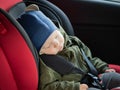 Close Up caucasian cute baby boy sleeping in modern car seat. Child traveling safety on the road. Safe way to travel Royalty Free Stock Photo