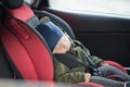 Close Up caucasian cute baby boy sleeping in modern car seat. Child traveling safety on the road. Safe way to travel Royalty Free Stock Photo