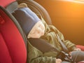 Close Up caucasian cute baby boy sleeping in modern car seat. Child traveling safety on the road. Safe way to travel Royalty Free Stock Photo