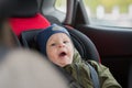 Close Up caucasian cute baby boy woke up and yawns in modern car seat. Child traveling safety on the road. Safe way to Royalty Free Stock Photo