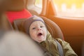 Close Up caucasian cute baby boy woke up and yawns in modern car seat. Child traveling safety on the road. Safe way to Royalty Free Stock Photo