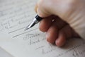 Close-up of a Caucasian female hand holding a fountain pen and signing a purchase contract Royalty Free Stock Photo