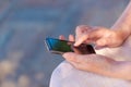 Close up of caucasian female hands using mobile phone outdoors Royalty Free Stock Photo