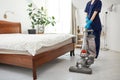 Floor care and cleaning services with vacuume cleaner at hotel room