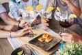 Close up of caucasian hands holding cocktail and wine glass all together on a table enjoying friendship and leisure fun people Royalty Free Stock Photo