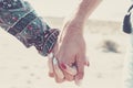 Close up of caucasian hands holding with love and relationship outdoor - young and adult man and woman couple concept - together Royalty Free Stock Photo