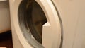 Close Up of Caucasian Male Hand Opening and Closing the Door of an Empty White Washing Machine