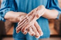 Close-up of a caucasian mans hand in a thick soapy foam while washing hands