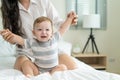 Close up of Caucasian mother play with baby boy child on bed at home. Happy family, attractive young woman mom take care of Royalty Free Stock Photo