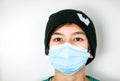 Close-up of caucasian teen boy  with face mask looking into camera. Attentive people with protection over mouth and nose from fron Royalty Free Stock Photo