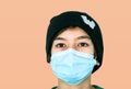 Close-up of caucasian teen boy  with face mask looking into camera. Attentive people with protection over mouth and nose from fron Royalty Free Stock Photo