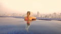 CLOSE UP: Woman enjoying a morning dip in the pool while observing the city. Royalty Free Stock Photo