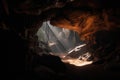 close-up of cave entrance, with light shining in Royalty Free Stock Photo