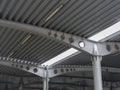 A close-up of a ceiling of a huge covered parking place. Inside bright view of iron construction as a background.