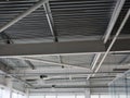 A close-up of a ceiling in a huge shopping centre. Inside bright view of iron structure construction as a background. Royalty Free Stock Photo