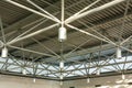 A close-up of a ceiling with lanterns and metal beams in a shopping centre. Inside view of iron structure construction as a Royalty Free Stock Photo