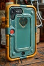 A close up of a cell phone case with an orange heart, AI