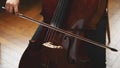 Close up of cello with bow in hands