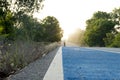 Close up center of blue bike lane on an asphalt road. with blurred of bike look out towards the end of the road. Royalty Free Stock Photo