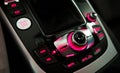 Close up of central car console with operating panel with buttons illuminate pink light