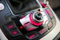 Close up of central car console with operating panel with buttons illuminate pink light