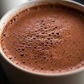 Close-up of a ceramic cup filled with frothy hot chocolate. The surface is adorned with Royalty Free Stock Photo