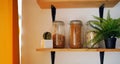 Close up of cereals in cans on shelf. Raw pasta products in glass jars in kitchen.