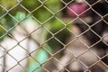Close up Chain Fence. Metal mesh . Dirty fence with blurred background. Royalty Free Stock Photo