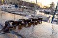 Close-up of a chain in la rochelle harbor. Boats in the background are very blurry