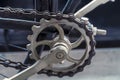 Close up of a chain, sprocket and pedals