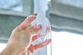 Close-up of chain with weight for opening and closing roman blinds Royalty Free Stock Photo