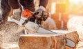 Close-up chainsaw of woodcutter sawing chain saw in motion, sawdust fly to sides. Concept is to bring down trees Royalty Free Stock Photo